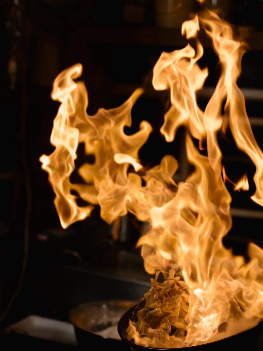 A high flame in the kitchen, with the pot on the burner